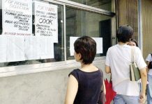 A Filipino woman checks a job placement agency’s announcement in Manila for cooks and factory workers in Taiwan. FILE PHOTO FROM AGENCE FRANCE-PRESSE/ROME GACAD