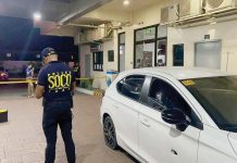 A Scene of the Crime Operative (SOCO) personnel examines the vehicle used by the drug suspects following the buy-bust operation in Barangay Balabago, Jaro, Iloilo City. ICPO PHOTO