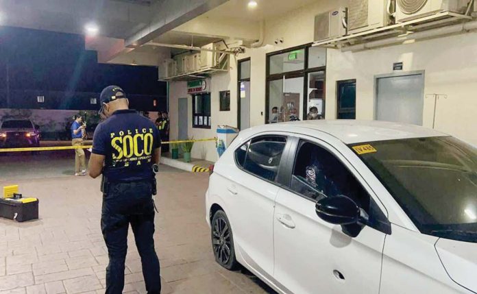 A Scene of the Crime Operative (SOCO) personnel examines the vehicle used by the drug suspects following the buy-bust operation in Barangay Balabago, Jaro, Iloilo City. ICPO PHOTO