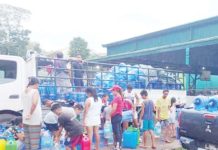 Residents of La Castellana, Negros Occidental displaced by the eruption of Mt. Kanlaon line up for drinking water in one of the evacuation centers on Dec. 28, 2024. PIO NEGROS OCCIDENTAL PHOTO