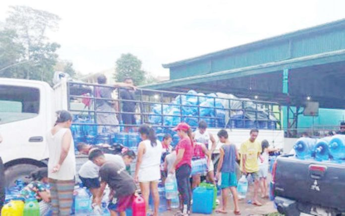 Residents of La Castellana, Negros Occidental displaced by the eruption of Mt. Kanlaon line up for drinking water in one of the evacuation centers on Dec. 28, 2024. PIO NEGROS OCCIDENTAL PHOTO