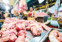 A vendor has an abundant supply of different pork meat and other by-products at a market in Quezon City on Jan. 14, 2025. PNA PHOTO BY JOAN BONDOC