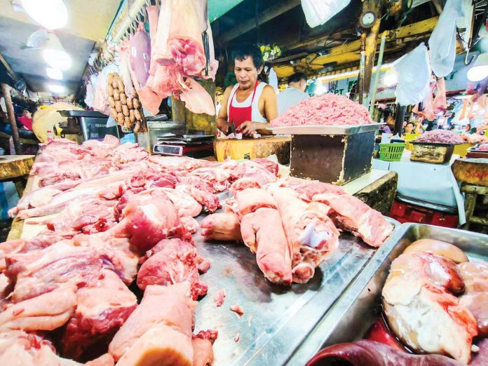 A vendor has an abundant supply of different pork meat and other by-products at a market in Quezon City on Jan. 14, 2025. PNA PHOTO BY JOAN BONDOC