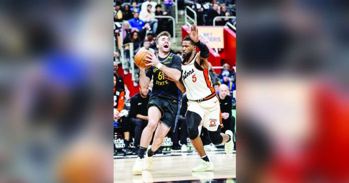 Golden State Warriors guard Pat Spencer (61) tries to score against the defense of Detroit Pistons guard Malik Beasley (5). Photo courtesy of Junfu Han/Detroit Free Press