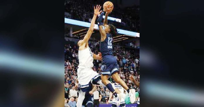 Memphis Grizzlies' Ja Morant attacks the defense of Minnesota Timberwolves' Rudy Gobert for an inside hit. AP PHOTO