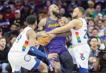 PHILADELPHIA 76ers’ Justin Edwards and Eric Gordon converge upon LeBron James of Los Angeles Lakers during the first half of their game. Photo courtesy of Charles Fox/The Inquirer