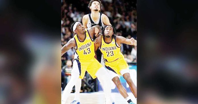 Indiana Pacers’ Paskal Siakam and Aaron Nesmith try to box out San Antonio Spurs center Victor Wembanyama. GETTY IMAGES