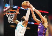 Nick Richards, then of Charlotte Hornets, grabs the rebound away from Phoenix Suns guard Devin Booker during the second half of their January 12 game at Footprint Center in Phoenix, Arizona. Photo courtesy of Mark J. Rebilas-Imagn Images