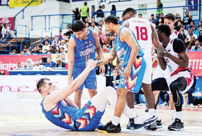 Sam Deguara is picked up by his Zamboanga Valientes’ teammates after going down with a hit from an opponent. PHOTO COURTESY OF DUBAI BASKETBALL CHAMPIONSHIP