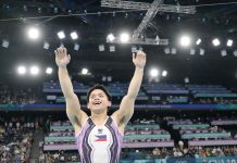 Filipino gymnast Carlos Edriel Yulo raises his arms after winning the vault event of the 2024 Paris Olympics. FIG