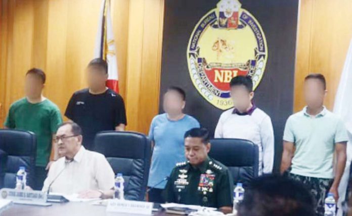 National Bureau of Investigation director Jaime Santiago and Armed Forces of the Philippines chief Gen. Romeo Brawner (both seated) on Jan. 30 presentED the five alleged Chinese spies arrested during operations in various locations from Jan. 24 to 25. The five were accused of engaging in intelligence, surveillance, and reconnaissance operations using sophisticated equipment. PNA