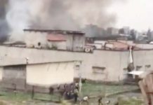 Footage from a jailbreak in Congo shows people fleeing from the building as black smoke rises into the air. BBC