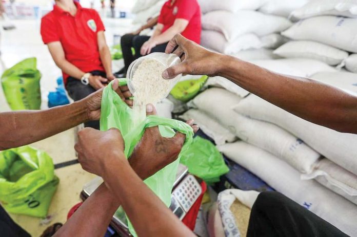 Residents buy cheap rice at a Kadiwa store at the Bureau of Plant Industry headquarters in Manila. JONATHAN CELLONA, ABS-CBN NEWS/FILE PHOTO