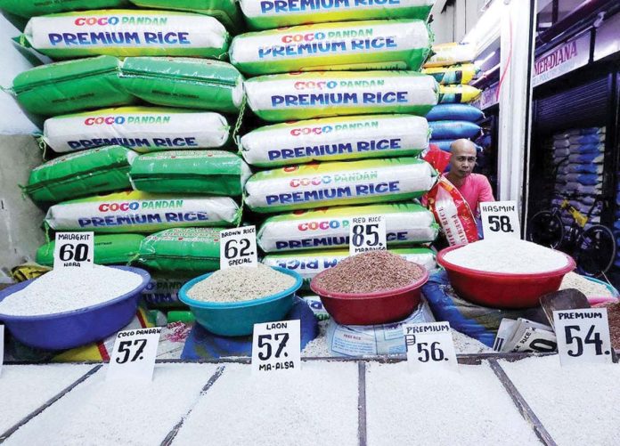 Rice vendor Eddie Pascual waits for customers at Marikina Public Market on Monday as the Department of Agriculture says it will announce “very soon” the maximum suggested retail price for imported rice to help lower prices. GRIG C. MONTEGRANDE, INQUIRER FILE PHOTO