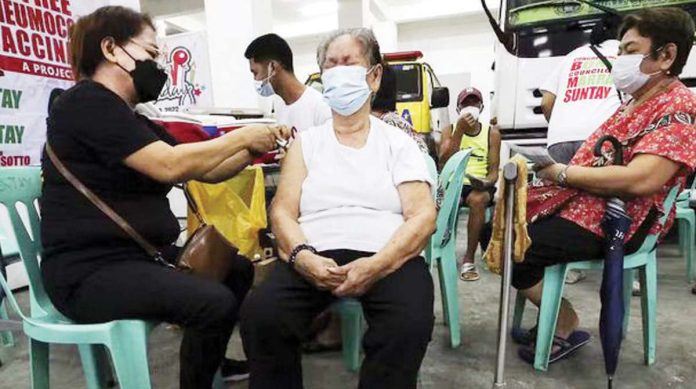 File photo shows a Quezon City health worker inoculating a resident against influenza and pneumococcal infection. INQUIRER FILE PHOTO