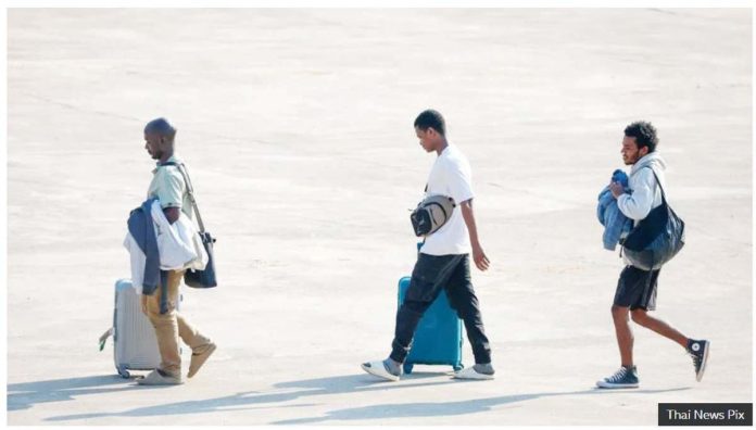 Three people released from scam centers walk across a tarmac in Mynamar. The scammers look for workers with skills in the languages of those who are targeted for cyber-fraud, usually English and Chinese. THAI NEWS PIX