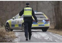 A police officers walks towards a police vehicle near the Risbergska School in Orebro, Sweden, on February 4, 2025, following reports of a serious violent crime. The attack in Orebro has been described as the “worst mass shooting in Swedish history”. AFP