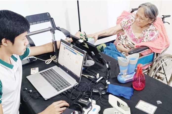 Despite difficulty in walking, a senior citizen visits Philippine Statistics Authority-Aklan’s registration center in her wheelchair to register for the national ID.