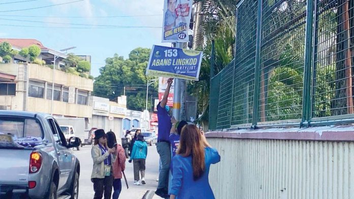 Personnel of the Commission on Elections (Comelec) in Bacolod City remove illegal campaign materials on Tuesday, Feb. 11, 2025, in Barangay Singcang-Airport.