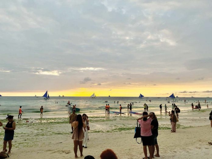 Visitors to Boracay Island currently pay P150 each in terminal and environmental fees, plus an additional environmental fee upon departure, alongside boat fare costs. MAI LADIAO PHOTO