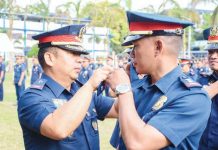 Brigadier General Jack Wanky, director of the Police Regional Office 6, administers the simultaneous oath-taking, donning, and pinning of ranks of the newly promoted officers on Thursday, Feb. 6, 2025. PRO-6 PHOTO