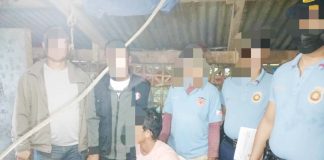 Alias “Bebot” (sitting) was caught with suspected shabu and a 12-gauge shotgun in a raid in Calinog, Iloilo on Monday morning, Feb. 10, 2025. CALINOG MUNICIPAL POLICE STATION PHOTO