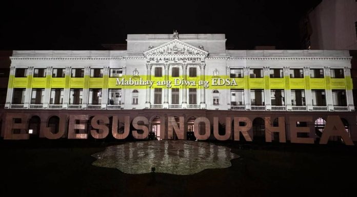 DLSU lights up St. La Salle Hall with a projection show honoring the 39th anniversary of the EDSA People Power Revolution. Photo courtesy of De La Salle University