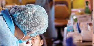 A dentist from the Iloilo Provincial Health Office (IPHO) attends to a child’s dental care in Carles, Iloilo, in November 2024. PHOTO COURTESY OF IPHO FACEBOOK PAGE