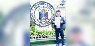 Former Iloilo City councilor Plaridel Nava II stands outside the Supreme Court, holding a copy of his petition challenging the executive clemency granted to former mayor Jed Patrick Mabilog.