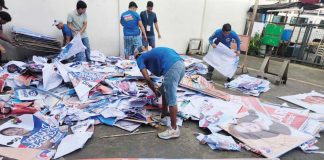 Workers sort and remove campaign materials during the “Operation Baklas” on February 14, following the grand rally of Alyansa Para sa Bagong Pilipinas’ senatorial candidates in Iloilo City. PHOTO FROM COMELEC-ILOILO CITY FACEBOOK PAGE