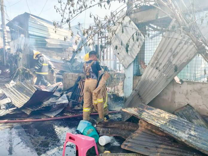 Firefighters conduct a mopping-up operation after a fire hit the relocation site in Barangay Buntatala, Jaro, Iloilo City on Sunday, Feb. 16, 2025. AJ PALCULLO/PN