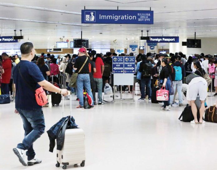 Arriving passengers queue at the immigration counters of the Ninoy Aquino International Airport terminal 1 in this file photo. GRIG C. MONTEGRANDE PHOTO/INQUIRER.NET