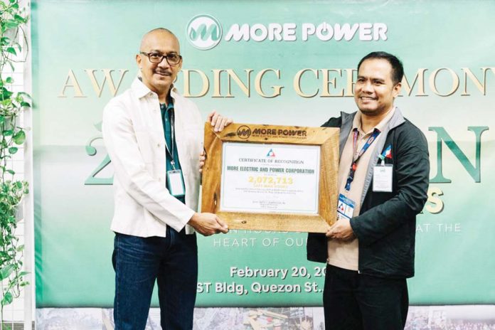 MORE Electric and Power Corporation receives the DOLE Safety Excellence Award for achieving 2,072,713 Safe Man Hours, recognizing its commitment to workplace safety. Engr. Bailey R. Del Castillo (left), VP for Network Development and Operations Group, accepted the award from Engr. Roberto Onde, Senior Labor Employment Officer of DOLE Region 6.