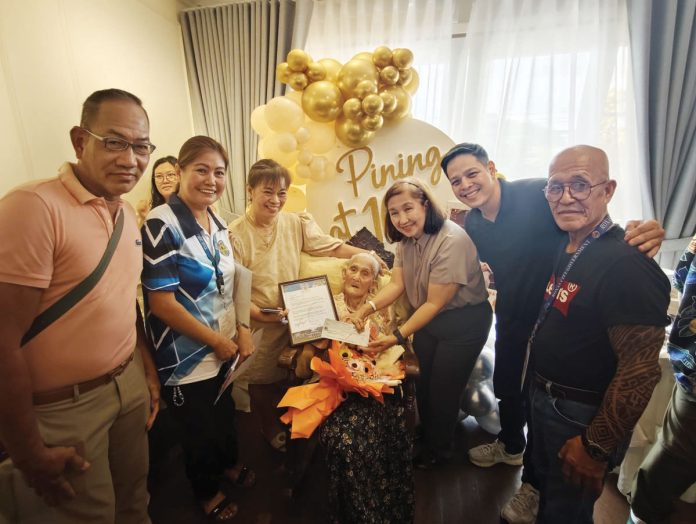 The 100-year-old Lola Josefina receives a P50,000 cash gift from the Roxas City Government. MAYOR RONNIE DADIVAS/FACEBOOK PHOTO