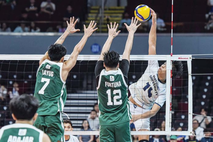 Negrense Leo Ordiales of National University Bulldogs scores against the defense of De La Salle University Green Spikers. UAAP PHOTO