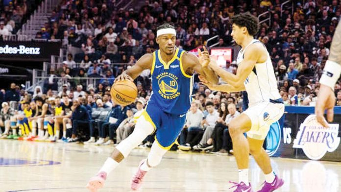 Golden State Warriors’ Jimmy Butler wards off the defense of Dallas Mavericks’ Max Christie. PHOTO COURTESY OF JOHN HEFTI/IMGN IMAGES