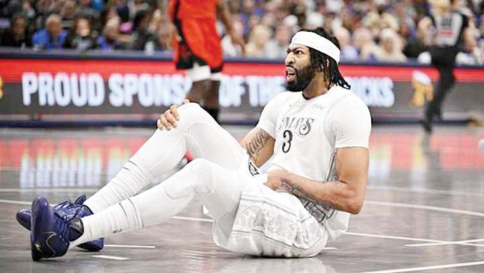 Dallas Mavericks’ Anthony Davis went down in the third quarter after experiencing tightness in his groin and quad area. JEROME MIRON//IMAGN IMAGES