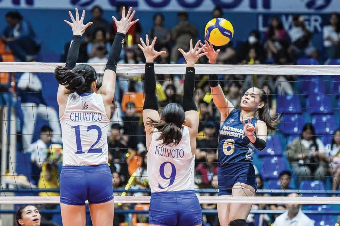 National University Lady Bulldogs’ Evangeline Alinsug drops the ball against the defense of Ateneo de Manila University Blue Eagles' Takako Fujimoto. UAAP PHOTO