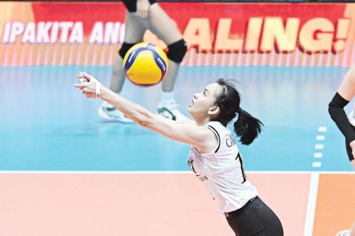 Negrense Cassie Carballo of University of Santo Tomas Golden Tigresses saves the ball. UAAP PHOTO