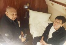 Former President Rodrigo Duterte talks with his former Executive Secretary Salvador Medialdea on board the chartered jet taking them to The Hague, in this picture released by Sen. Bong Go on Wednesday. Photo from REUTERS, AP, SEN. BONG GO/FACEBOOK