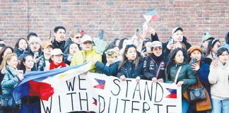 Supporters of former president Rodrigo Duterte wait for his arrival at the Scheveningen detention cell in The Hague, Netherlands. REUTERS