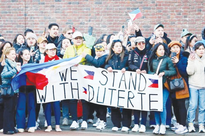 Supporters of former president Rodrigo Duterte wait for his arrival at the Scheveningen detention cell in The Hague, Netherlands. REUTERS