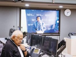 Former President Rodrigo Duterte makes his first appearance at the International Criminal Court via video link in The Hague, Netherlands. In this pre-trial hearing, the judges verified his identity, informed him of the charges against him, and enumerated his rights. Also in photo is Salvador Medialdea, his executive secretary during his term. INQUIRER.NET