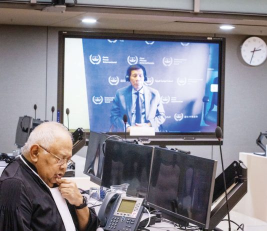 Former President Rodrigo Duterte makes his first appearance at the International Criminal Court via video link in The Hague, Netherlands. In this pre-trial hearing, the judges verified his identity, informed him of the charges against him, and enumerated his rights. Also in photo is Salvador Medialdea, his executive secretary during his term. INQUIRER.NET