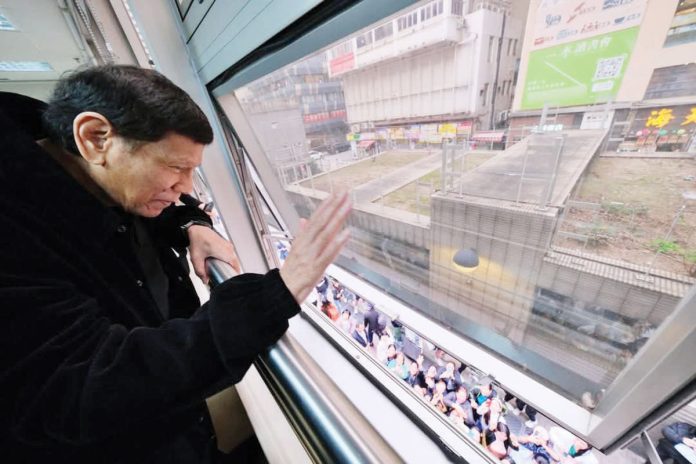 Former president Rodrigo Duterte waves to a crowd of Filipinos waiting outside the Southorn Stadium in Wan Chai, Hong Kong on Sunday. PHOTO COURTESY OF KING RODRIGUEZ