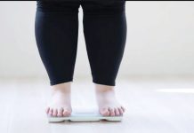 Researchers warn that obesity levels are predicted to accelerate rapidly during the remainder of this decade, particularly in lower-income countries. Photo shows a woman who is overweight standiing on a weighing scale. GETTY IMAGES