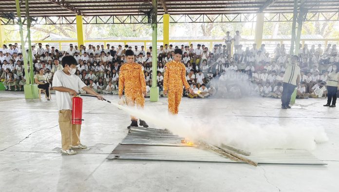 Personnel of the Mansilingan Fire Sub-Station lead a fire drill in Antonio L. Jayme Elementary School in Barangay Mansilingan, Bacolod City. Photo shows firefighters teaching pupils how to use the fire extinguisher to put out fire. MANSILINGAN FIRE SUB-STATION PHOTO