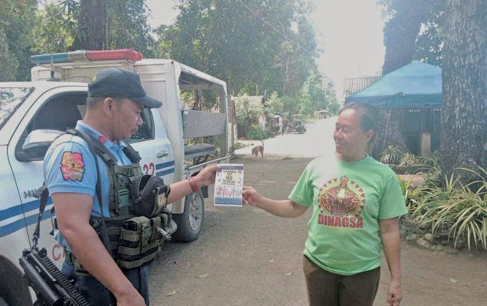 Dumalag police conduct community engagement thru dialogue and distribution of infographic materials related to the prohibited acts during election period, strict implementation of the Commission on Elections gun ban, and anti-illegal drugs campaign, among others in Barangay Poblacion, Dumalag, Capiz, on March 13, 2025. DUMALAG MUNICIPAL POLICE STATION PHOTO