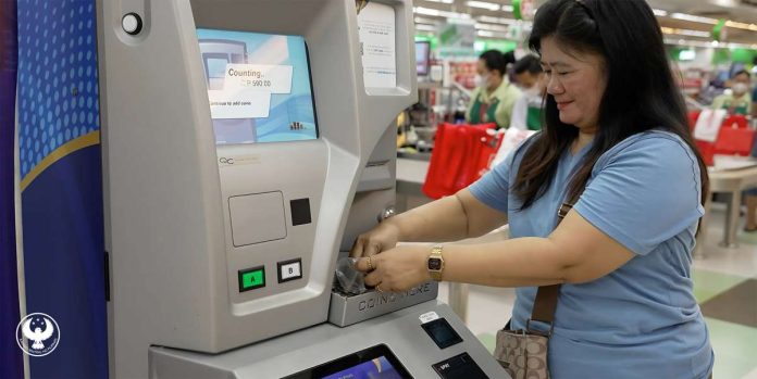 Sari-sari store owner Vilma Guray deposits her coins in the coin deposit machine. The Bangko Sentral ng Pilipinas has collected more than P1.308 billion through its coin deposit machines as of Feb. 15, 2025. BANGKO SENTRAL NG PILIPINAS PHOTO