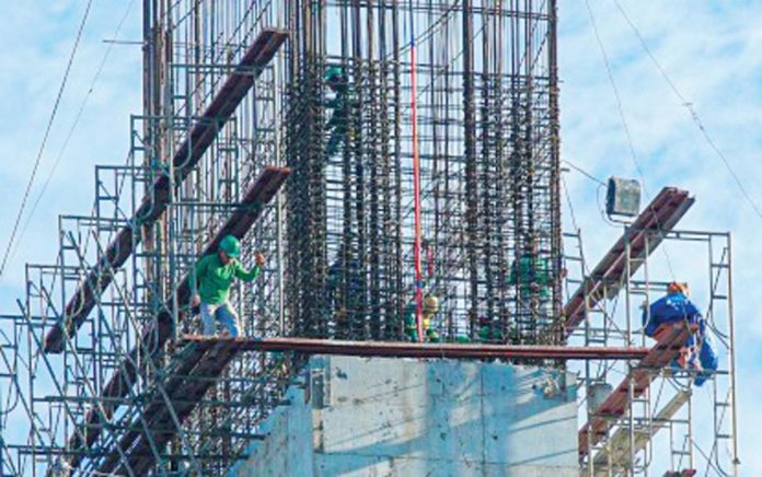 Workers construct the foundation of a building along Timog Avenue in Quezon City on Feb. 18, 2025. The Philippine Statistics Authority reported on Friday, March 21, 2025, that construction activities from approved building permits reached 12,526 in January this year. PNA PHOTO BY ROBERT OSWALD P. ALFILER